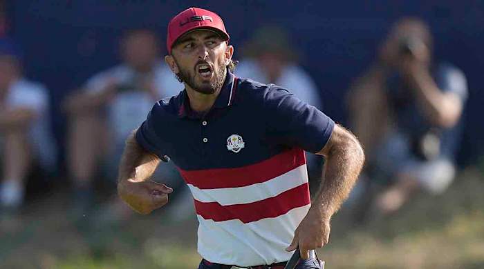Max Homa celebrates as he wins his singles match 1 up on the 18th green at the 2023 Ryder Cup.
